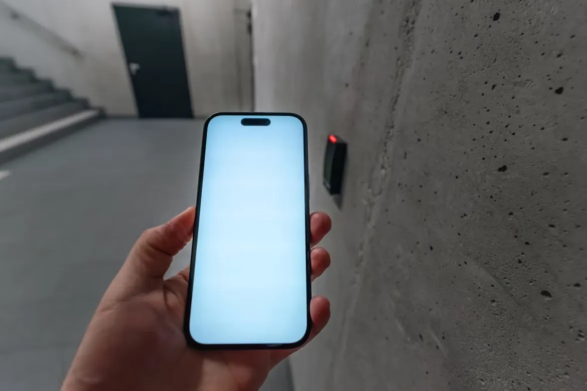 Person unlocking a secure door with a smartphone mobile credential at an access control reader