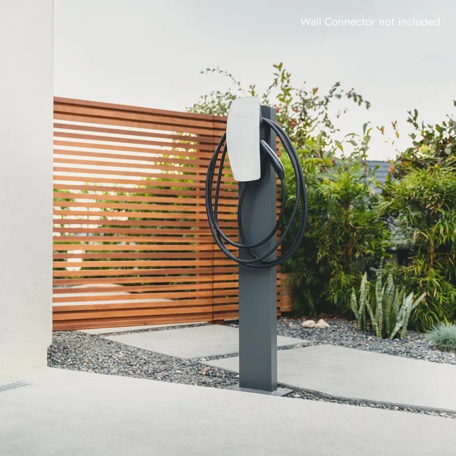 EV charger mounted on a pedestal beside a driveway